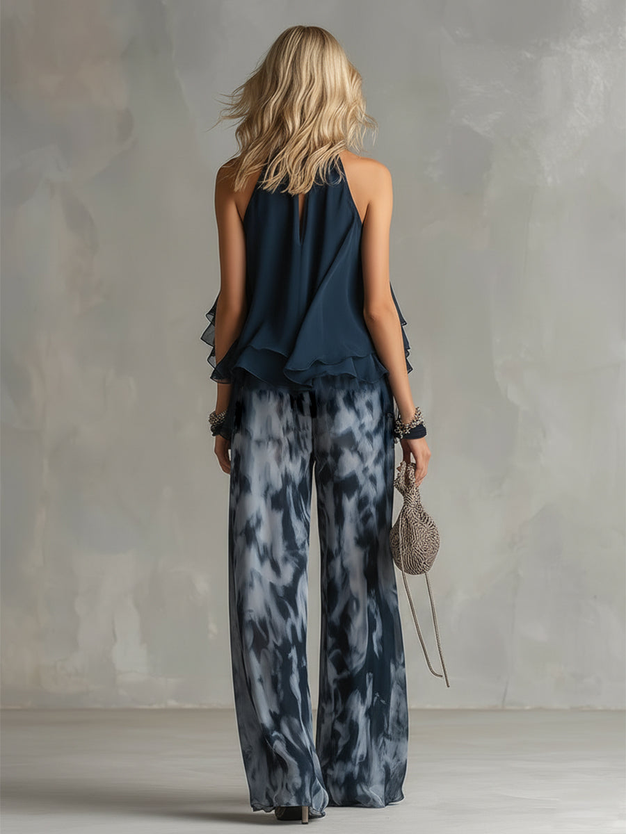 Chloé | Elegant set med marinblå halterneck och vida byxor med mönster